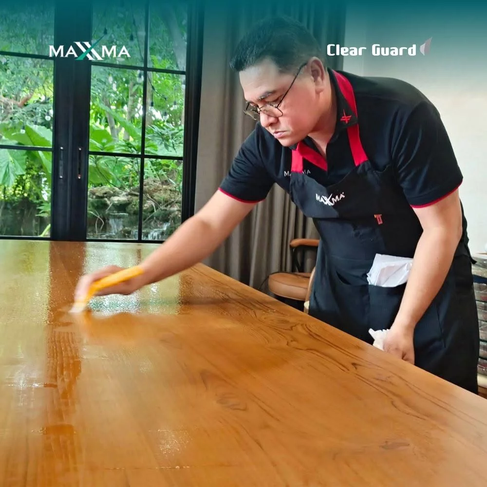 Precision squeegee technique following natural grain directions to safeguard underlying wood texture.